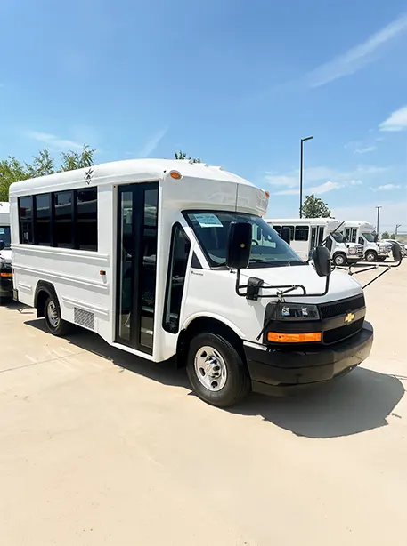 minibus in white parked in a large lot
