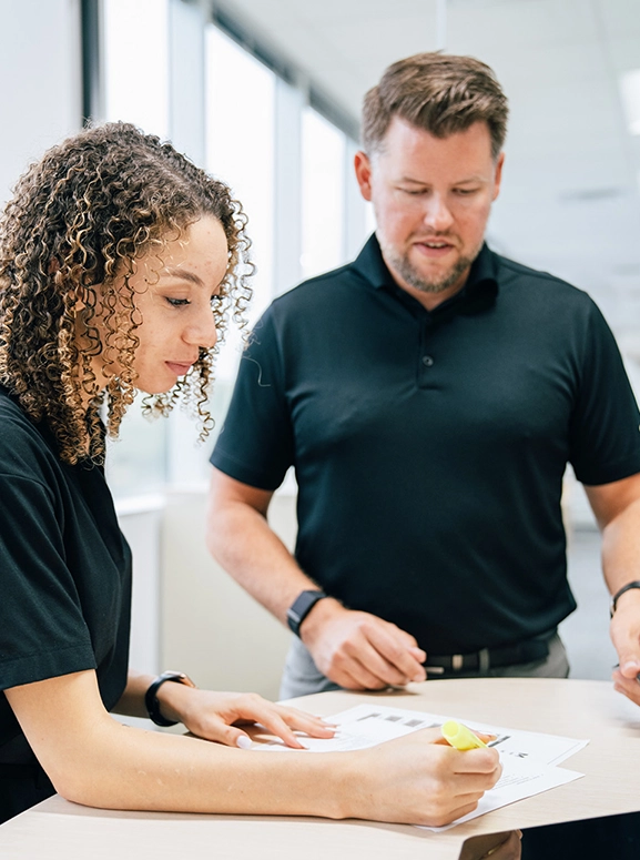 woman and man looking at forms for renting a vehicle in Denver
