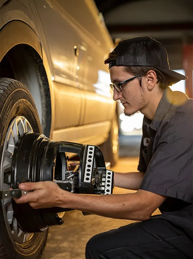 mechanic working on the wheel of a van
