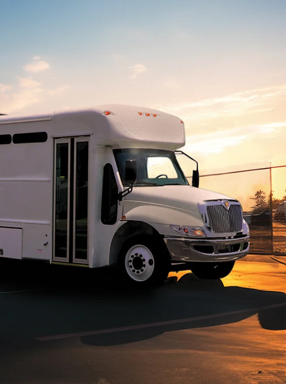 White shuttle bus parked next to a security fence at a prison near Richmond