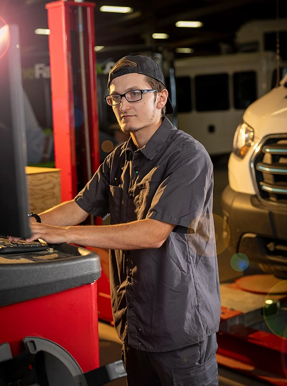 mechanic working on a vehicle diagnostic tool