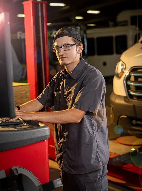 mechanic working on a vehicle diagnostic tool