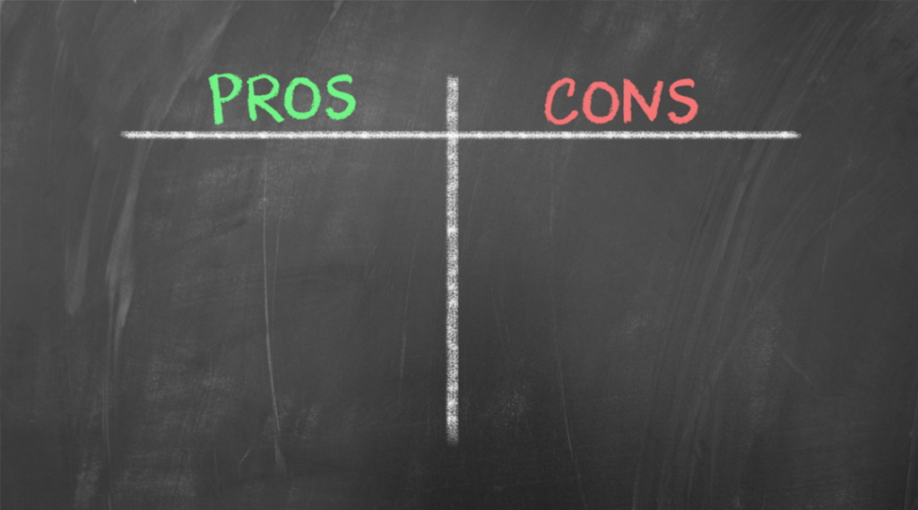 A blackboard with a pros and cons chart drawn on it.