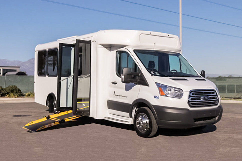 A white ARBOC Spirit of Independence wheelchair accessible van parked in a parking lot.