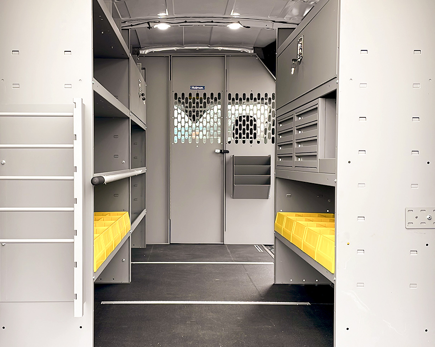 The inside of a van with shelves and drawers for electrical contractors