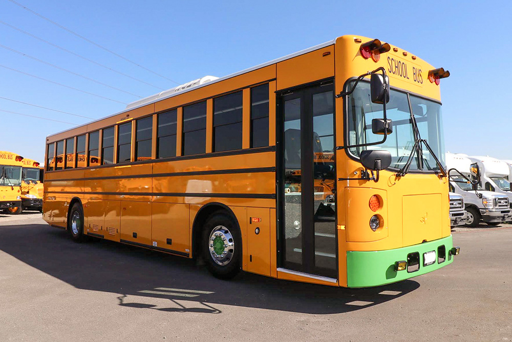 A yellow GreenPower Beast school bus parked in a parking lot.