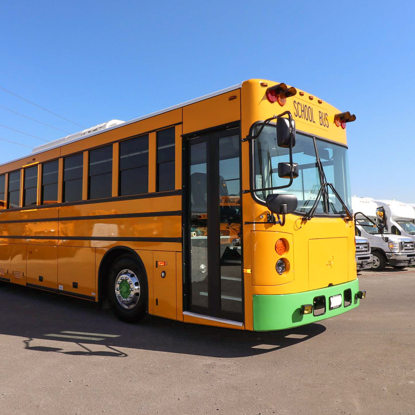 A yellow greenpower school bus parked in a parking lot.