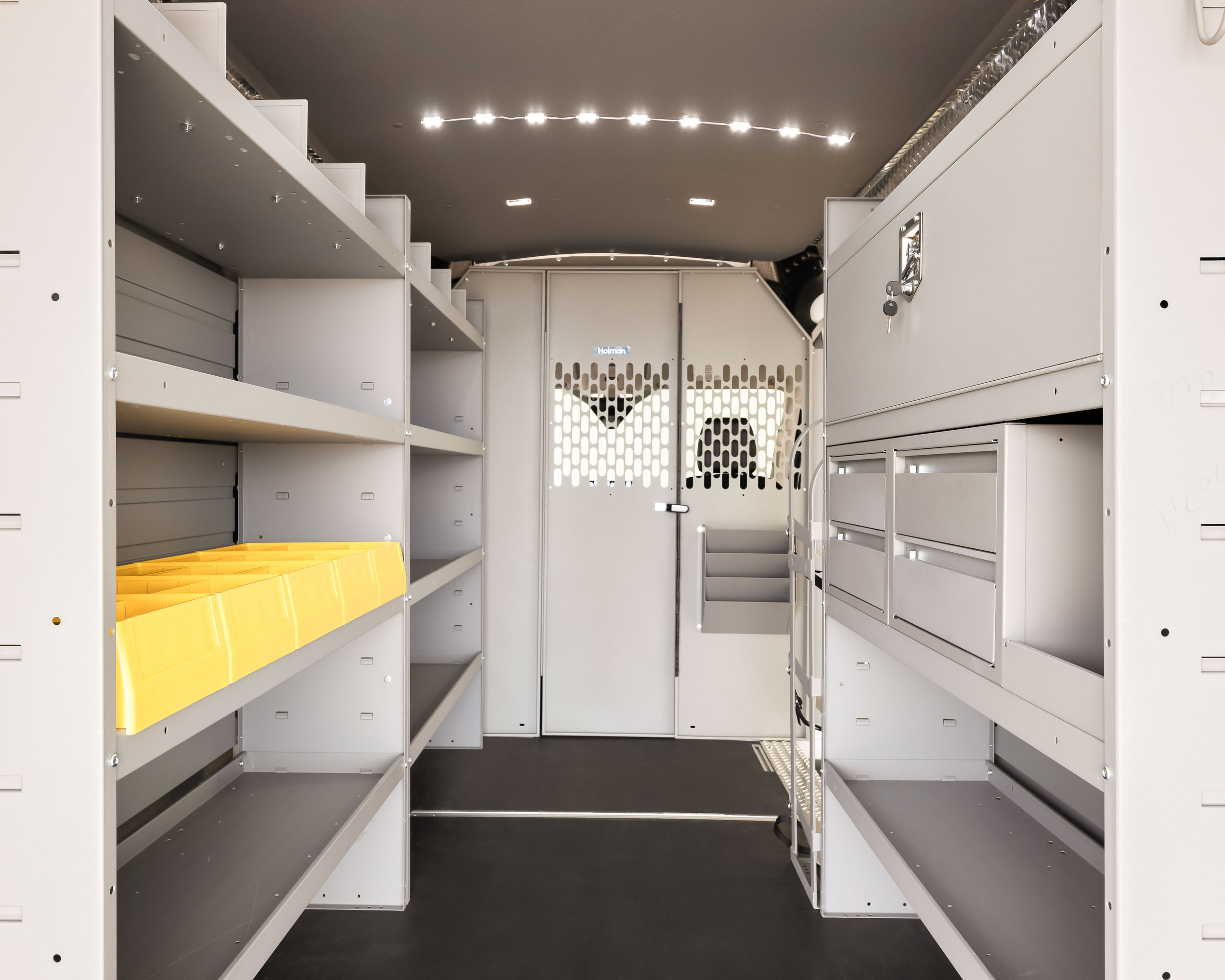 The interior of a van with shelves and drawers for HVAC contracters