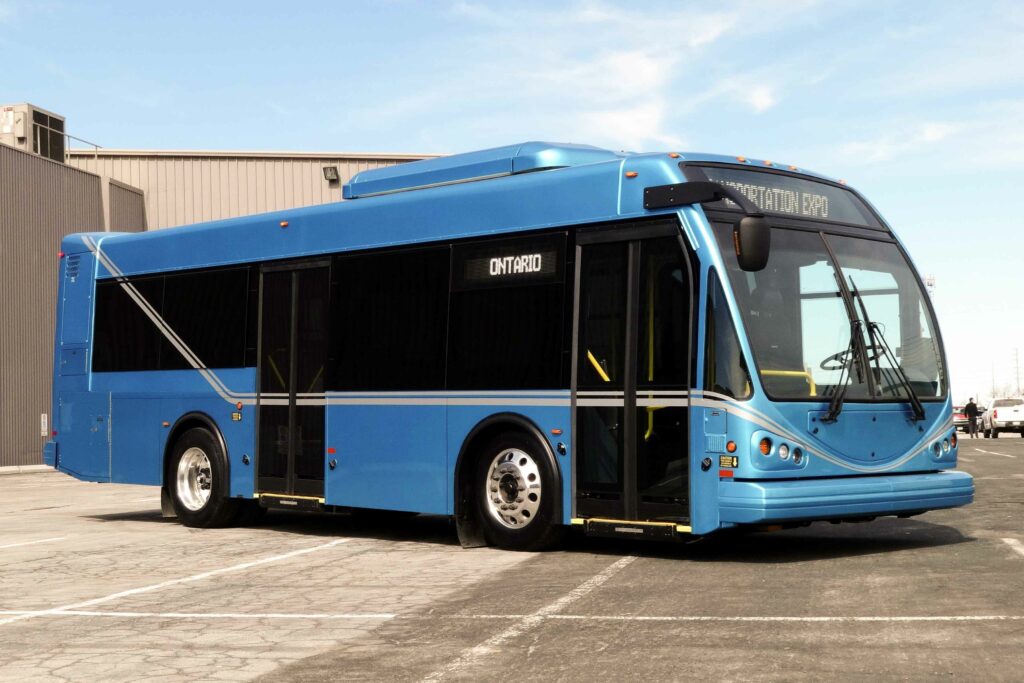 A blue heavy duty transit bus parked in a parking lot.