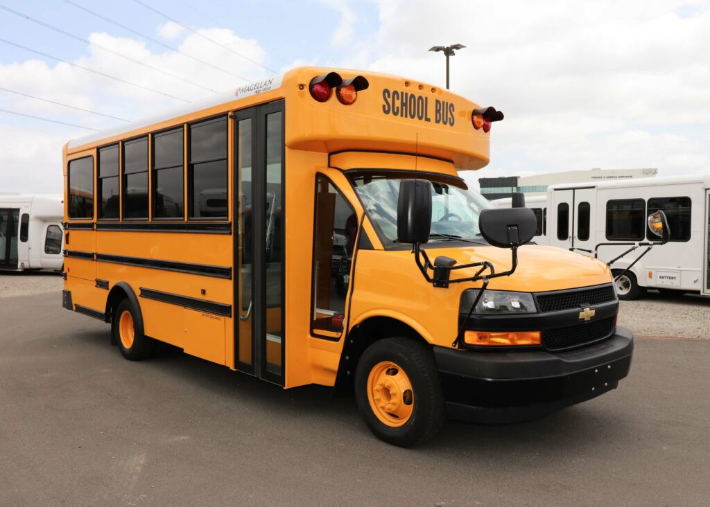 A yellow Magellan school bus is parked in a parking lot.