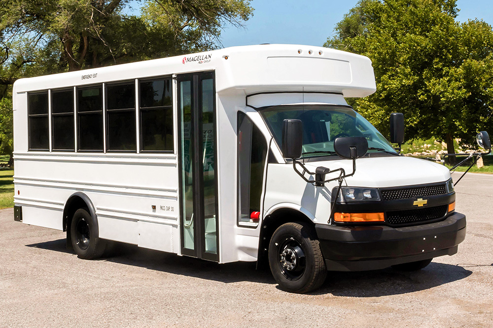 A white Magellan Type A MFSAB bus parked in a parking lot.