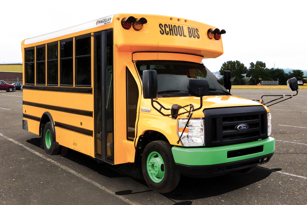 A Magellan Type A Electric school bus is parked in a parking lot.