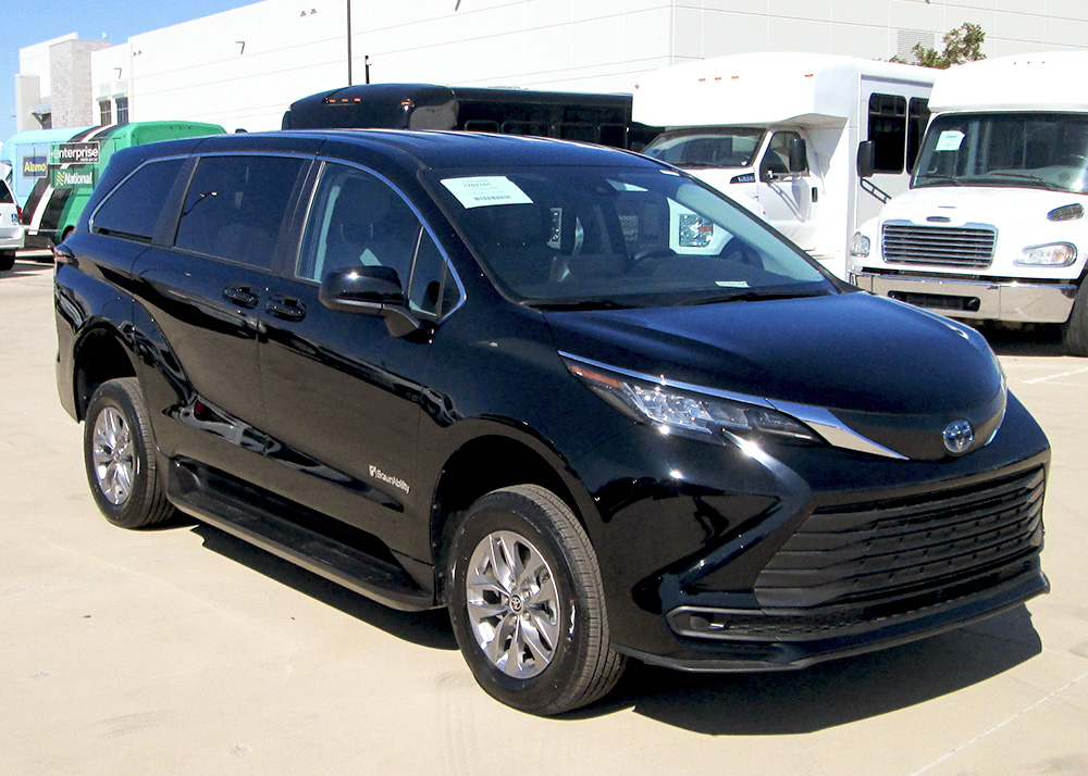 A black toyota sienna parked in a parking lot.