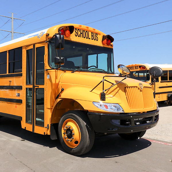 A yellow propane school bus parked in a parking lot.