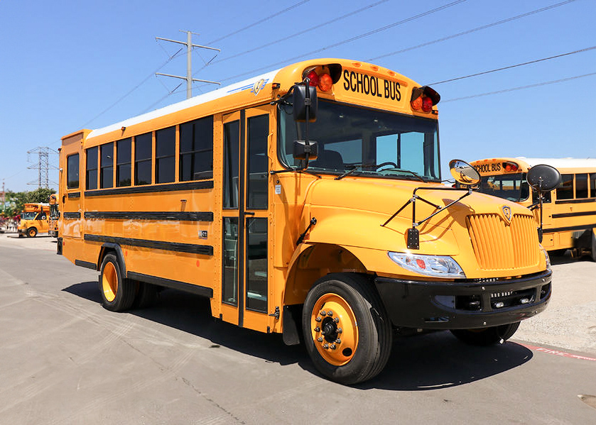 A yellow propane school bus parked in a parking lot