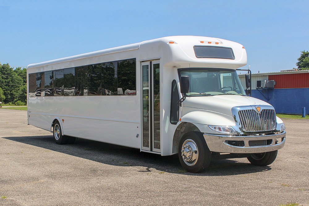 A white Starcraft Allstar XL 40 Corporate bus parked in a parking lot.