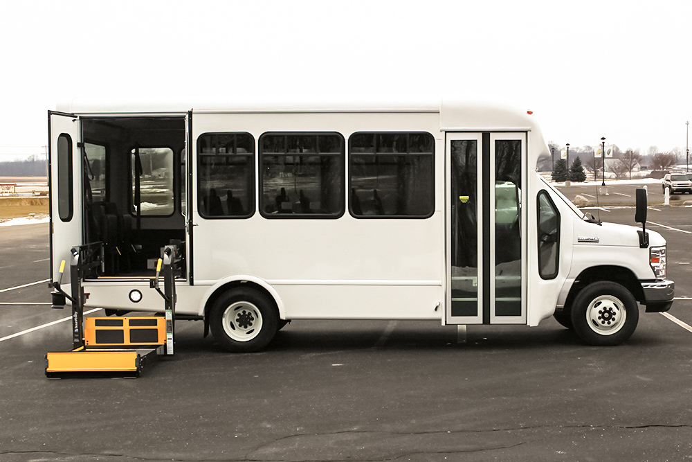 A white Starcraft Allstar wheelchair accessible bus parked in a parking lot.