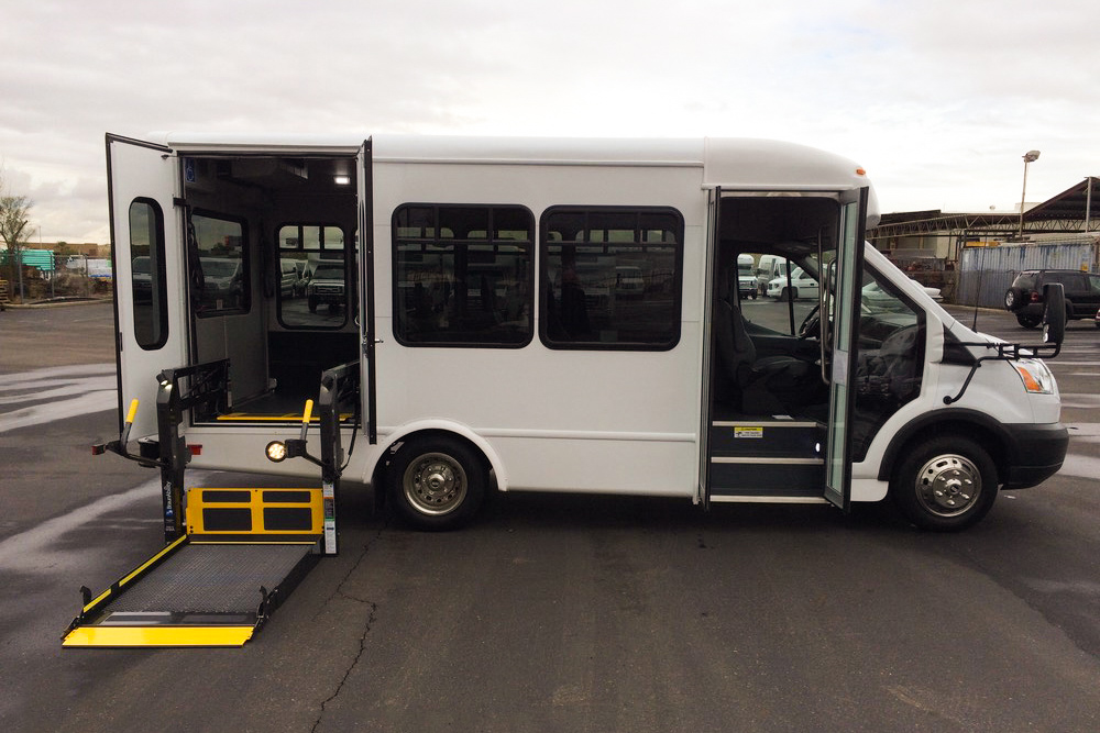A white Starcraft Starlite bus with a wheelchair ramp.