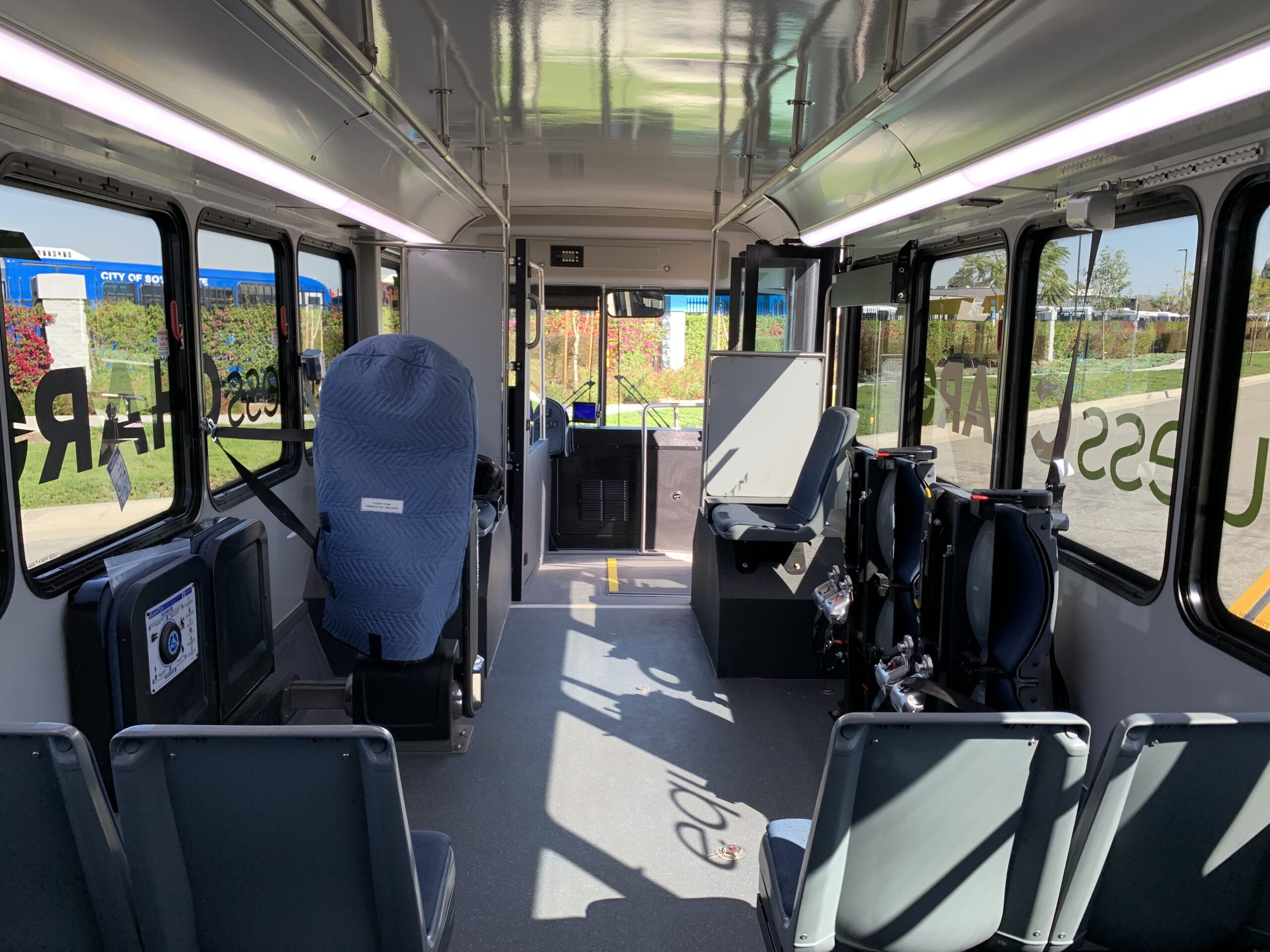 The inside of a 2021 ARBOC Equess CHARGE bus with seats.