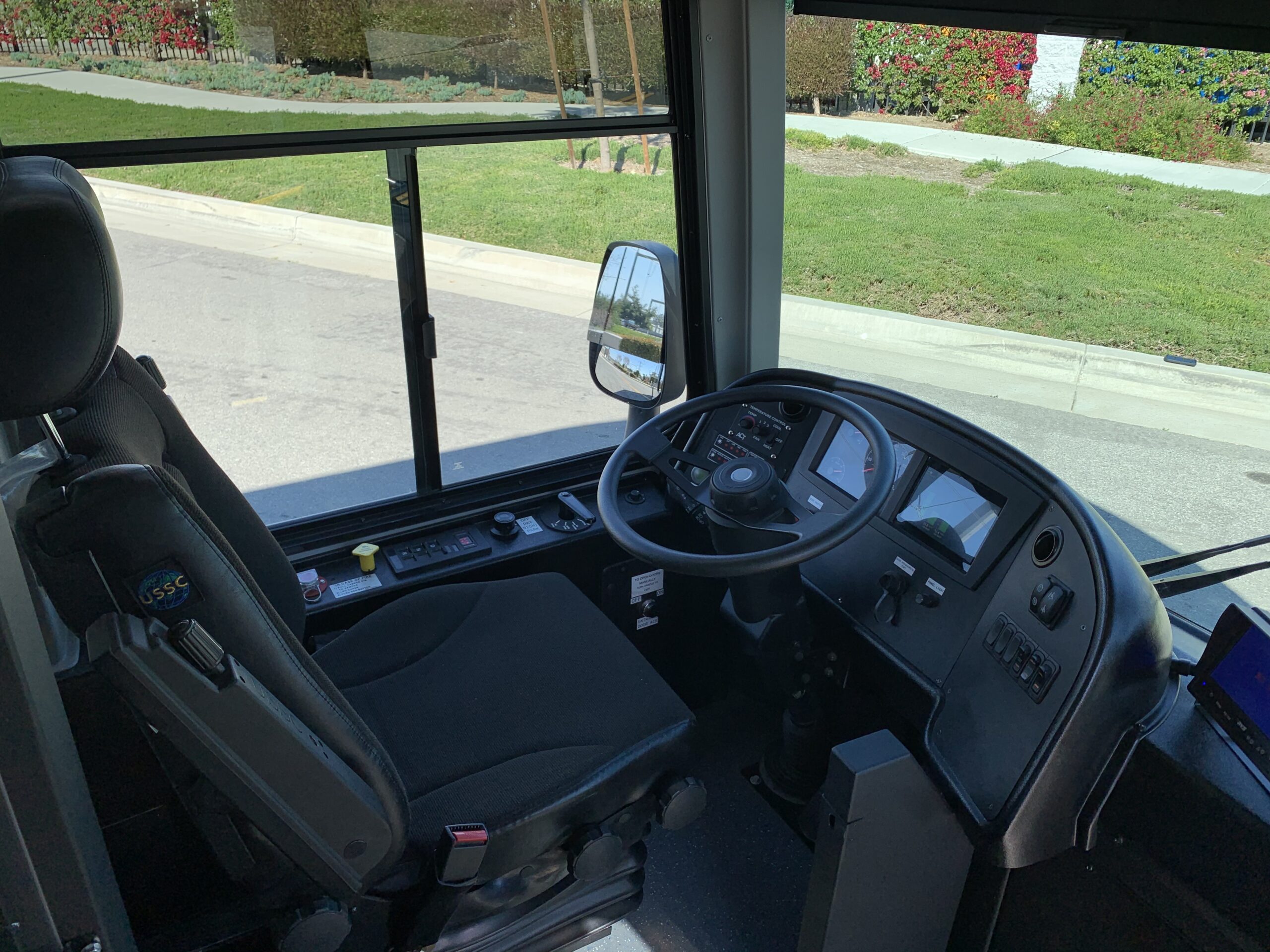 The inside of a 2021 ARBOC Equess CHARGE bus equipped with a seat and steering wheel.