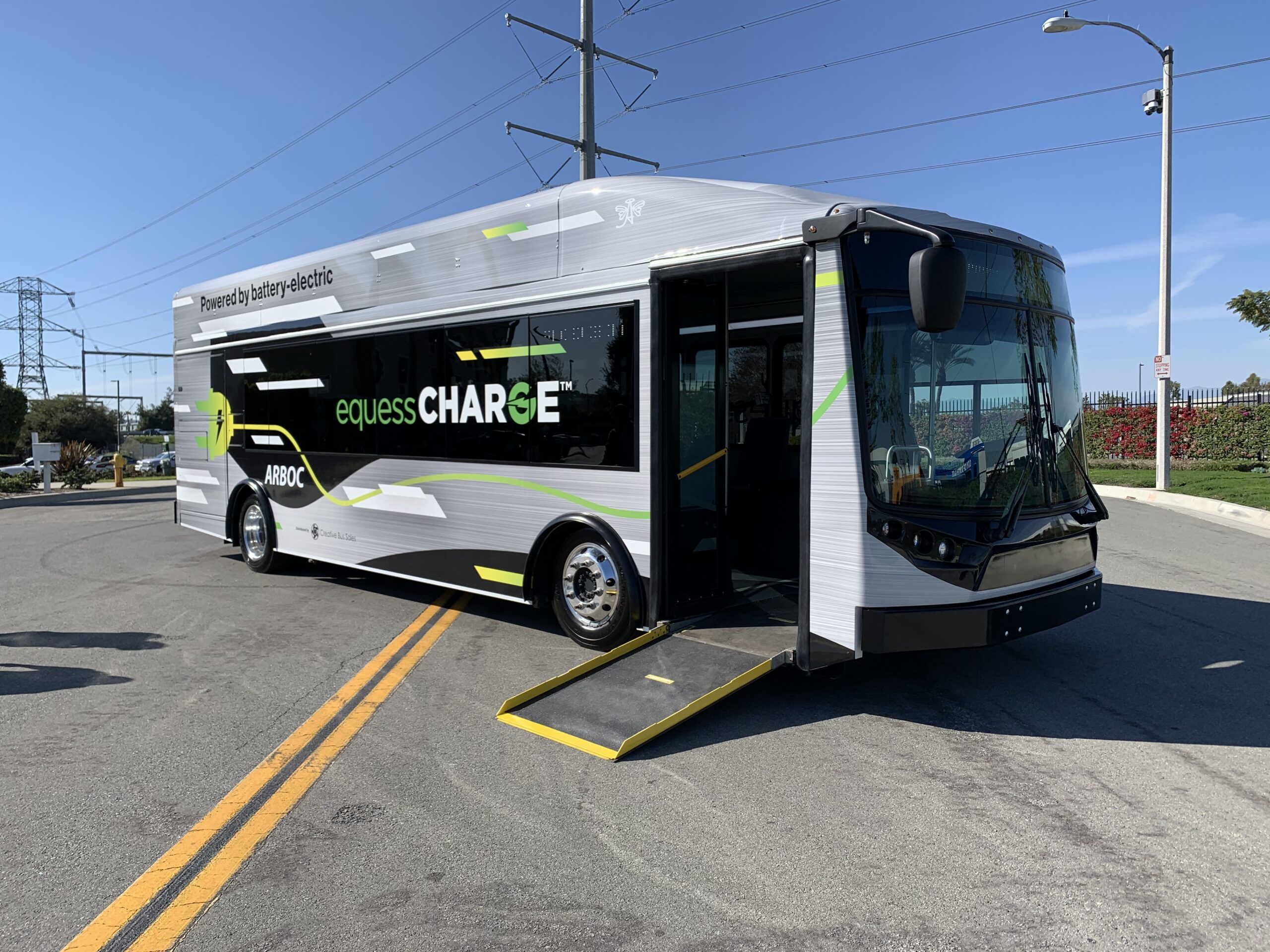 A 2021 electric bus is parked on the side of the road.