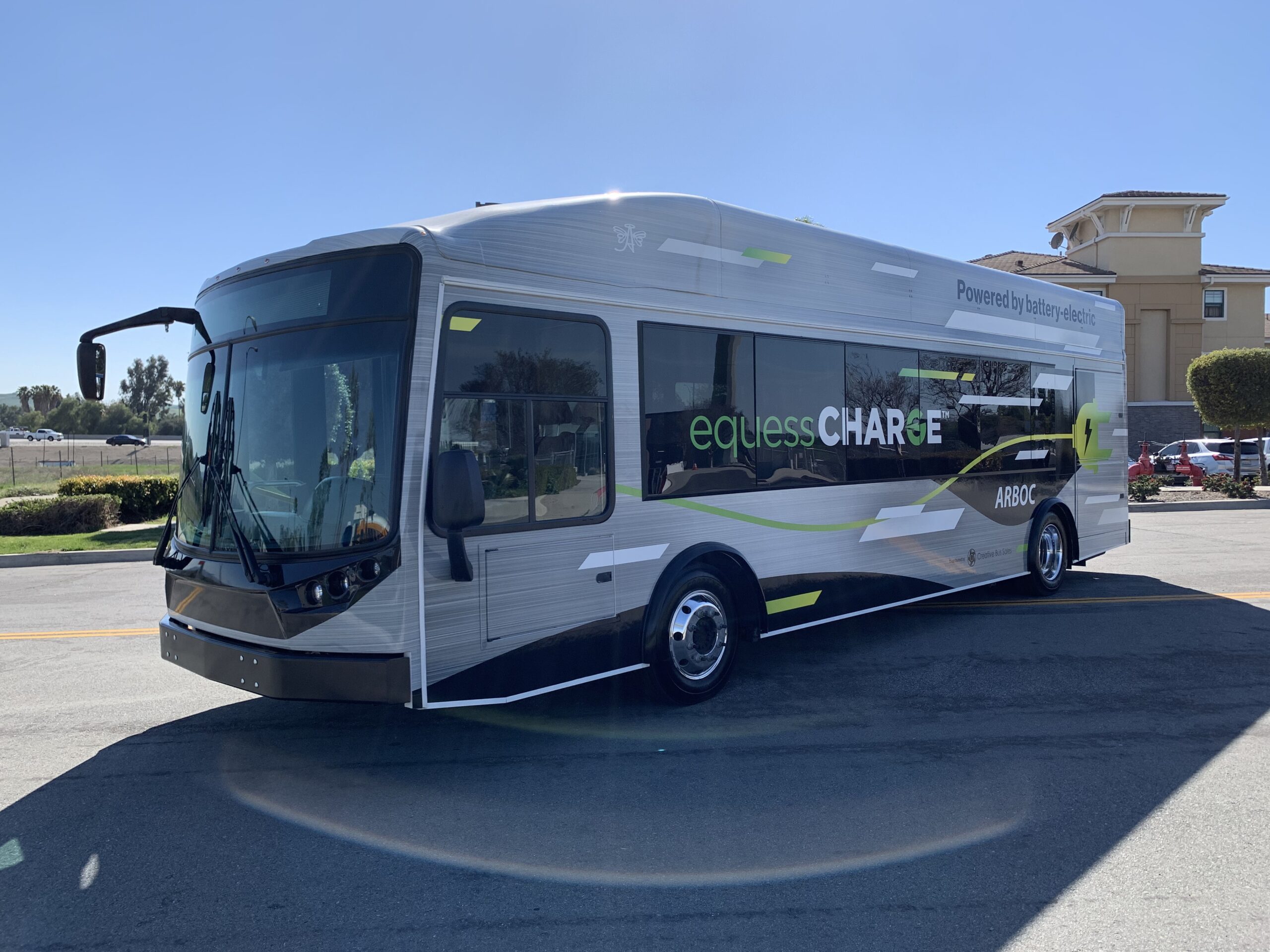 A 2021 electric bus parked in a parking lot.