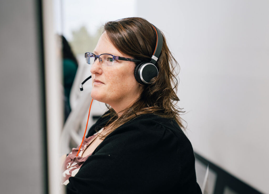 A woman wearing a headset in a call center.