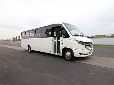 A white Marcopolo Grand bus parked in a parking lot.