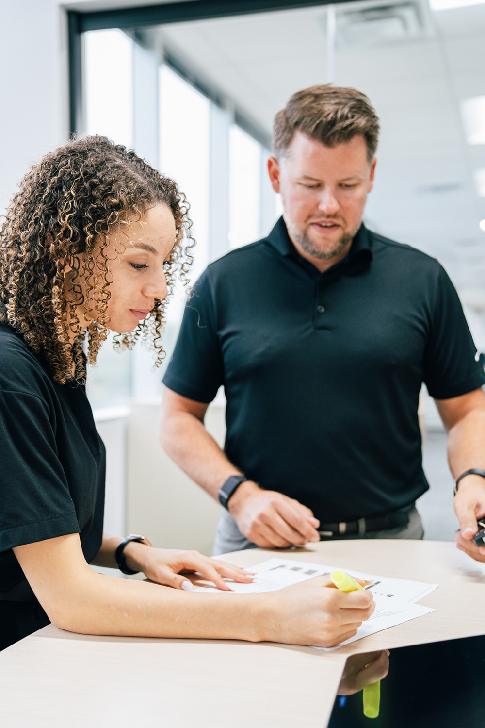 Model 1 employee and customer working together at a desk.