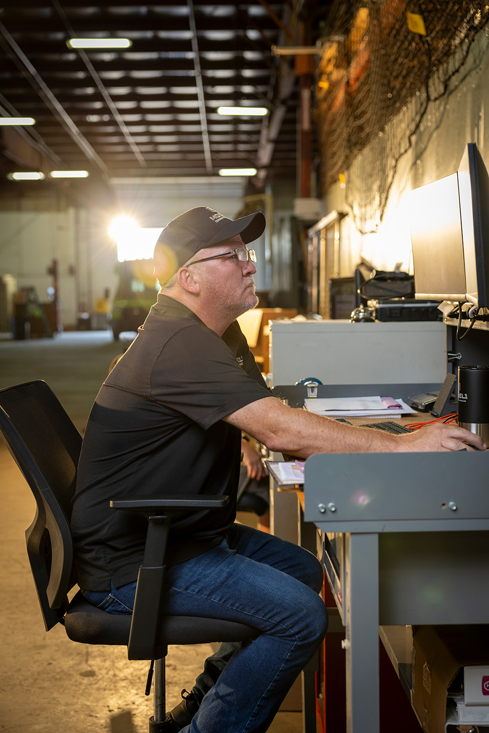 A man sitting at a desk at a computer.