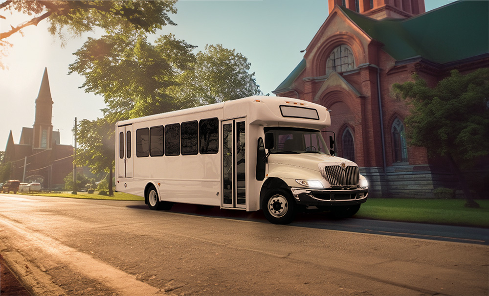 White bus driving in front a church