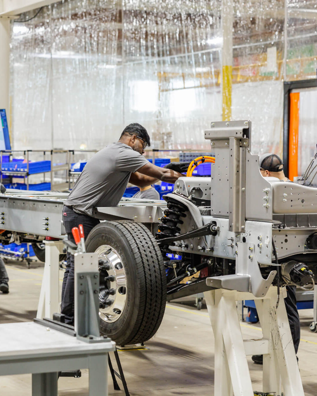 Harbinger technicians assembling a commercial vehicle chassis at a U.S. manufacturing facility.